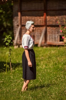 a woman in Ukrainian national costume walks on the lawn