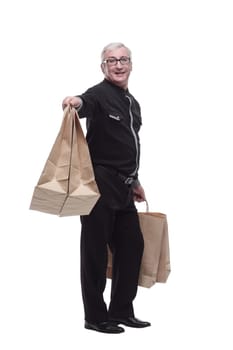 in full growth. happy casual man with shopping bags. isolated on a white background.