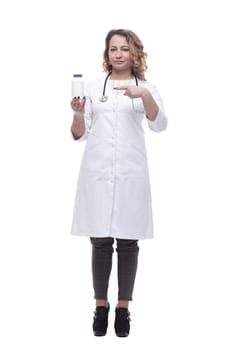 in full growth.young woman doctor showing her business card. isolated on a white background.