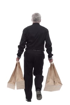 casual man with shopping bags striding forward. isolated on a white background.