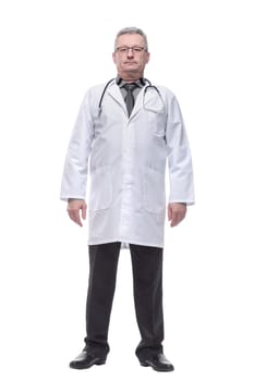 Handsome confident male doctor or surgeon standing gin a white coat with a blue tie and a stethoscope around his neck isolated on white background
