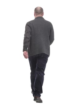 in full growth. Mature man in casual clothes striding forward.isolated on a white background.