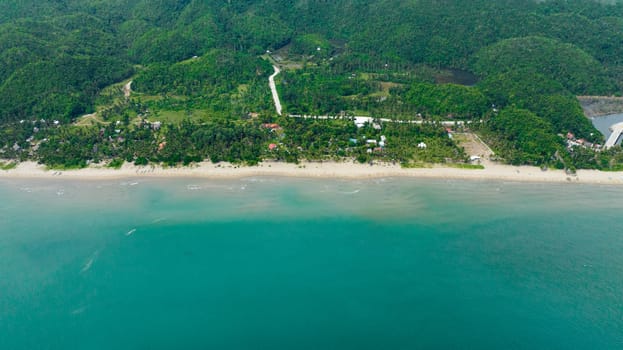 Tropical beach with palm trees. Sugar Beach. Sipalay, Negros, Philippines.