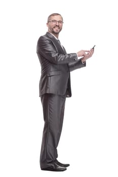 in full growth.Executive business man with a smartphone. isolated on a white background.glasses