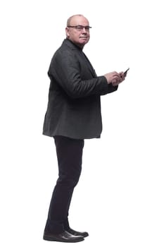 in full growth. business man talking on a smartphone . isolated on a white background