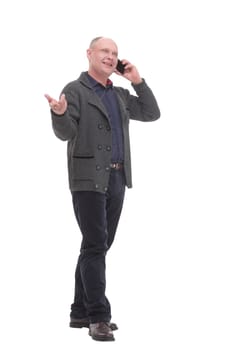 in full growth. smiling mature man with a smartphone .isolated on a white background.