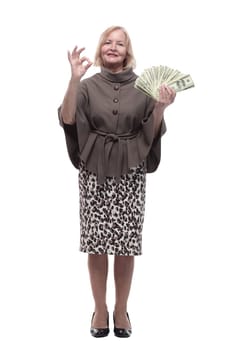 in full growth. happy mature woman with dollar bills . isolated on a white background.