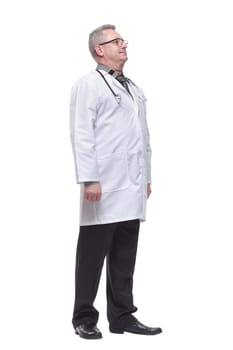 Smiling professional older man doctor wears white coat, glasses and stethoscope looking to the side
