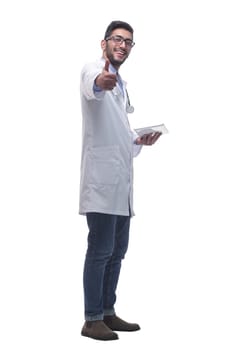 in full growth. male doctor using a digital tablet. isolated on a white background.