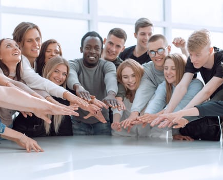 multinational group of young people joining their palms. photo with copy space