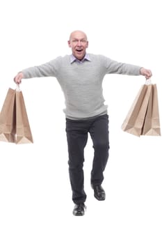 in full growth. happy man with shopping bags. isolated on a white background.