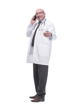 full-length. mature doctor with smartphone. isolated on a white background.