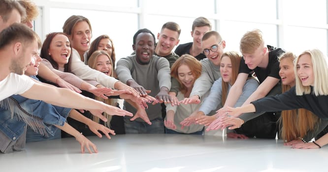 multinational group of young people joining their palms. photo with copy space