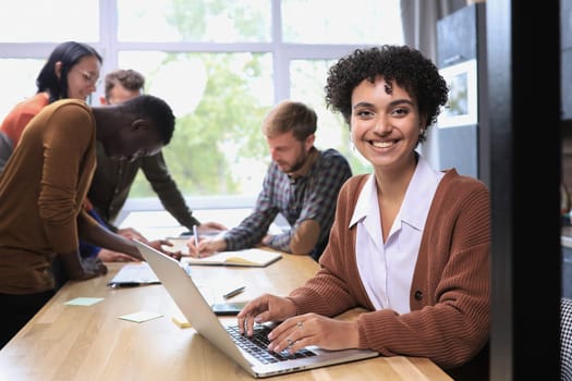 Portrait of charming successful cheerful focused girl working remotely creating finance it presentation report