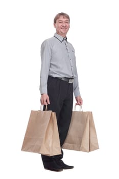 in full growth.senior man with shopping bags . isolated on a white background.