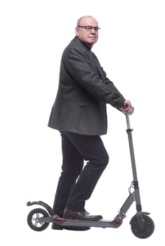 side view . Mature man with electric scooter looking forward. isolated on a white background