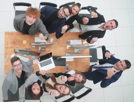 top view. business team celebrating near the desktop. concept of success
