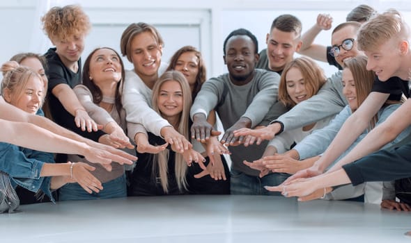 multinational group of young people joining their palms. photo with copy space