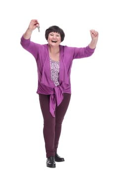 in full growth.happy senior woman with keys in hand. isolated on a white background.