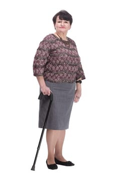 full-length. casual elderly woman with a walking stick. isolated on a white background.