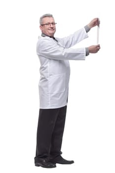 Side view of doctor having a close look at x-ray image while holding it against light