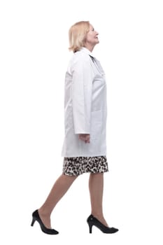 woman doctor in a white coat striding forward. isolated on a white background.