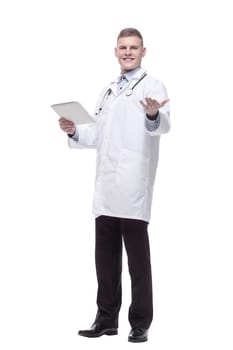 in full growth. young doctor with a digital tablet. isolated on a white background.