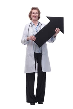 Friendly senior medical doctor pointing direction with arrow and looking at camera