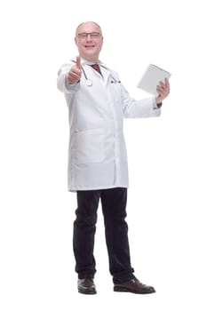 in full growth. modern mature doctor with a digital tablet. isolated on a white background.