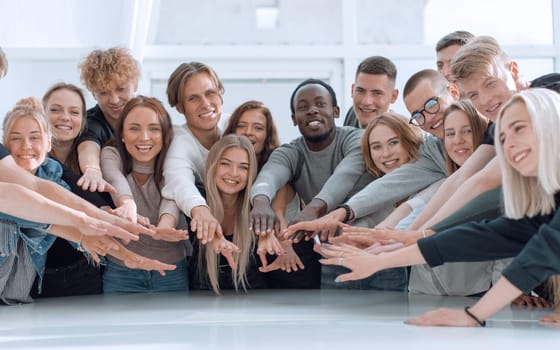 multinational group of young people joining their palms. photo with copy space