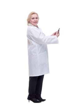 Back view of concentrated beautiful female doctor reading text message