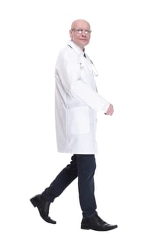 in full growth. man doctor striding forward confidently . isolated on a white background.