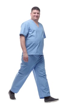 male medic confidently striding forward . isolated on a white background.