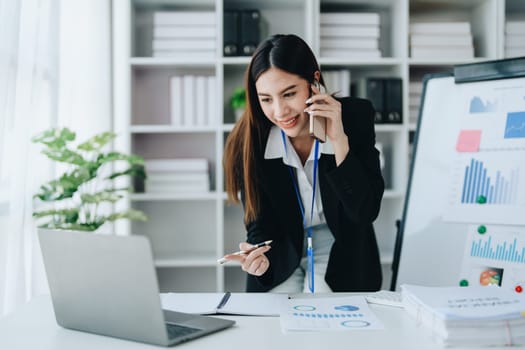 Portrait of young asian woman holding notebook with presentation of strategy, investment plan and marketing