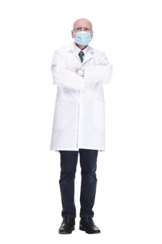 in full growth. male doctor in protective mask showing thumbs up . isolated on a white background.