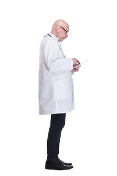side view. doctor with a digital tablet looking at a white screen. isolated on a white background.