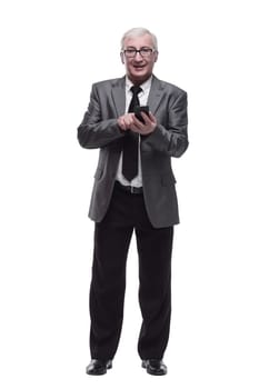 in full growth.Mature business man with a smartphone. isolated on a white background.