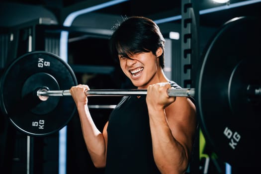 A bodybuilder holding a barbell and lifting weights for a strength-building workout in the gym, showcasing his muscular body and impressive lifting skills. power lifting training concept