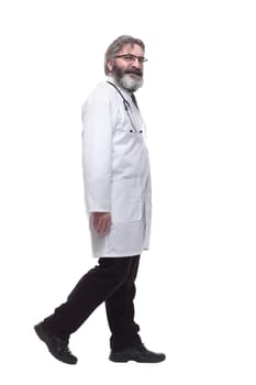 in full growth. confident male doctor striding forward. isolated on a white