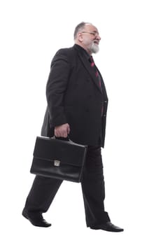 in full growth. business man with a briefcase walking forward. isolated on a white