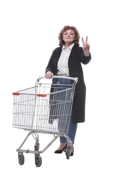in full growth. casual woman with shopping cart. isolated on a white background