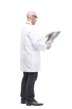 senior doctor with a stethoscope looking at an x-ray. isolated on a white background.