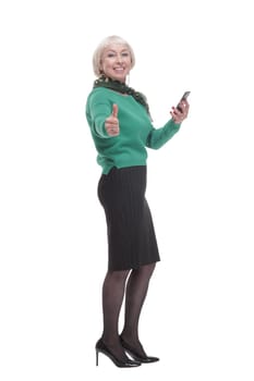 in full growth. attractive woman with a smartphone. isolated on a white background.