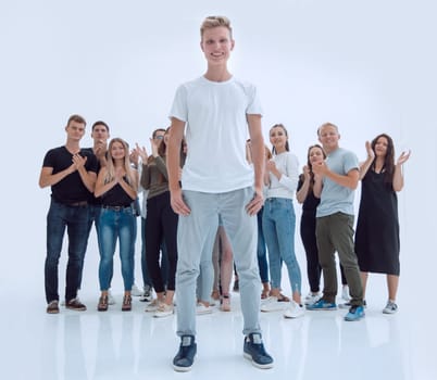 in full growth. casual guy standing in front of a group of diverse young people. photo with copy space