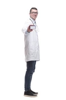doctor with a stethoscope showing his business card. isolated on a white background.