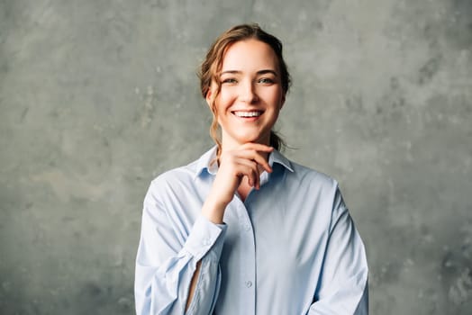 Confident Young Professional Woman Smiling. Vibrant young professional smiling confidently at the camera. Ideal for promoting a positive work environment, business success, and personal branding