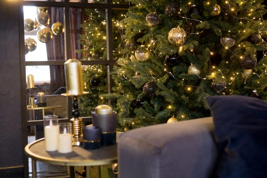 Christmas interior with a beautiful Christmas tree, sofa, light bulbs and dark background