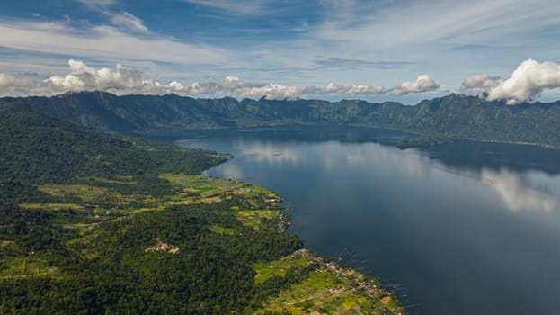 Aerial drone of blue lake Maninjau in a crater among the mountains. Sumatra, Indonesia.