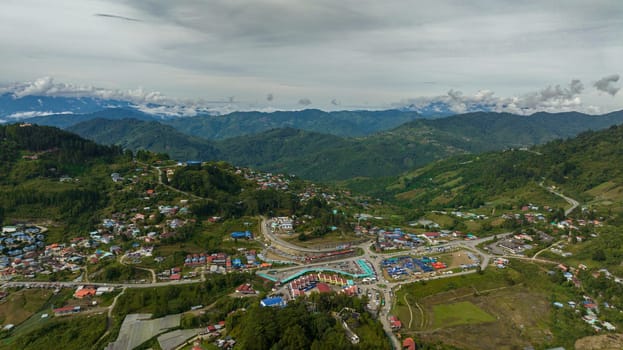Top view of city is located in the mountains among farmland at the foot of Mount Kinabalu. Kundasang, Ranau. Borneo, Sabah, Malaysia.