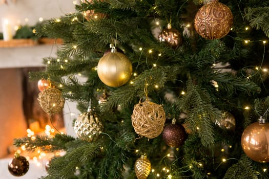 Bronze balls on the Christmas tree close-up. Christmas tree design decorations. The concept of celebrating New Year and Christmas